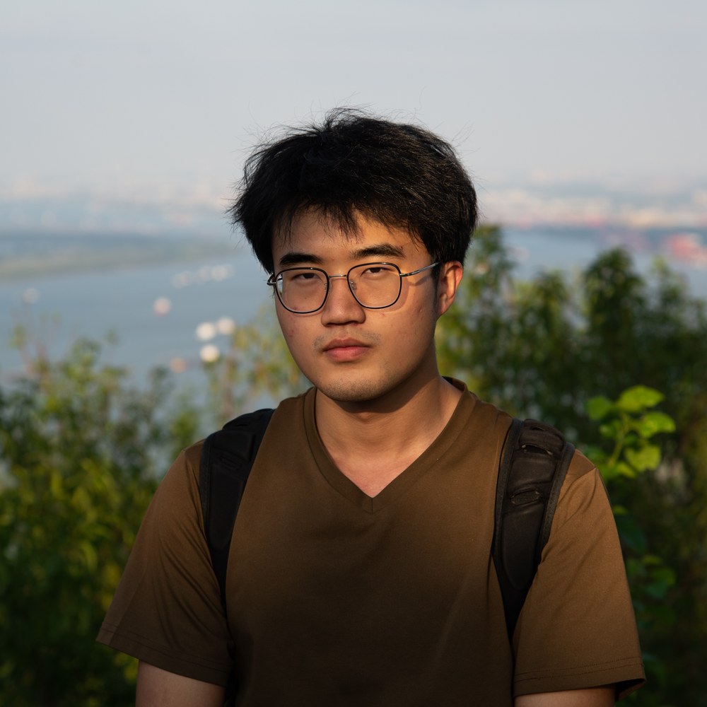 Portrait of Yu Chen at golden hour, overlooking a river